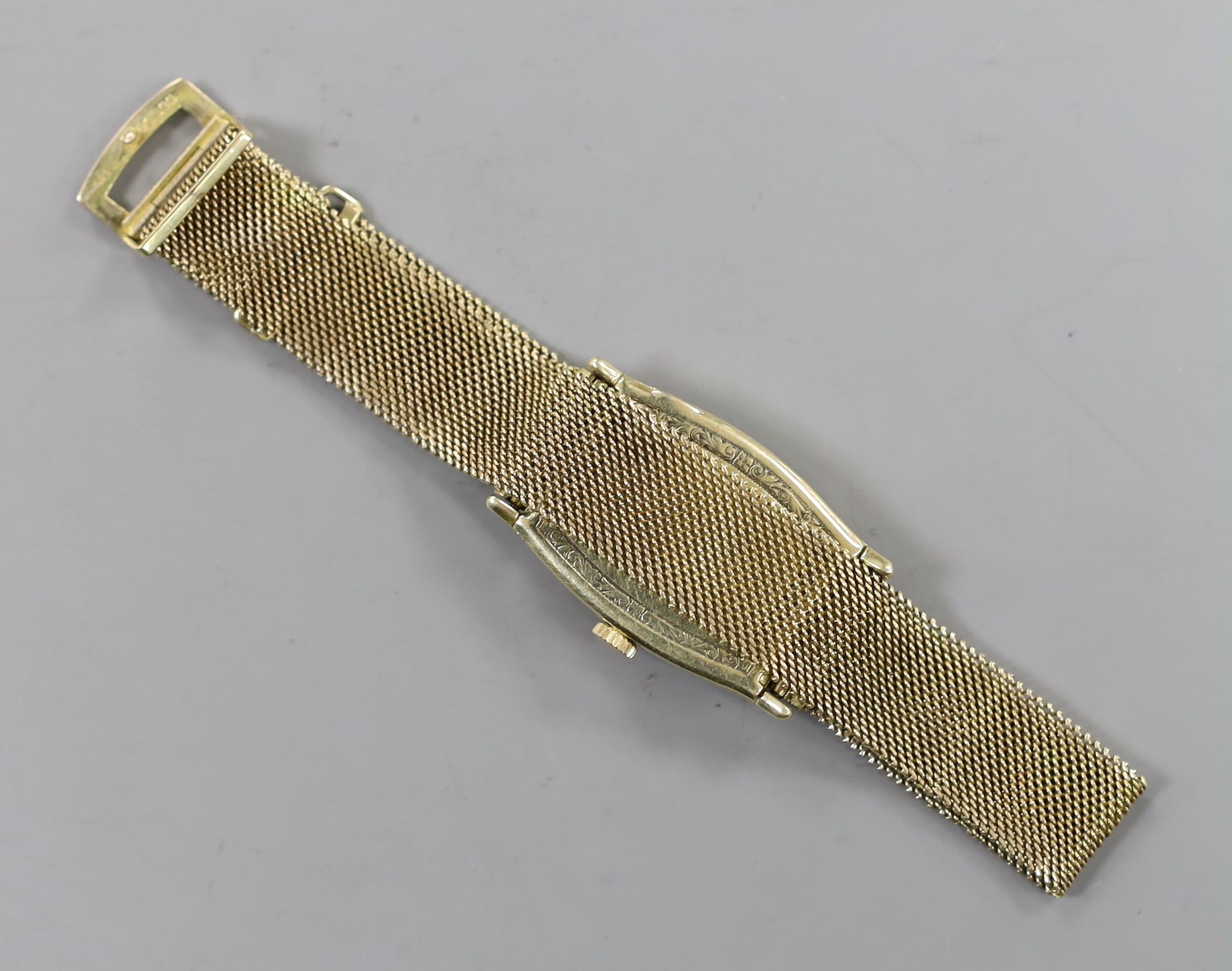 A gentleman's 14k tonneau shaped manual wind wrist watch, retailed by E. Cubelin, with Arabic dial and subsidiary seconds, on associated 9ct gold mesh link bracelet